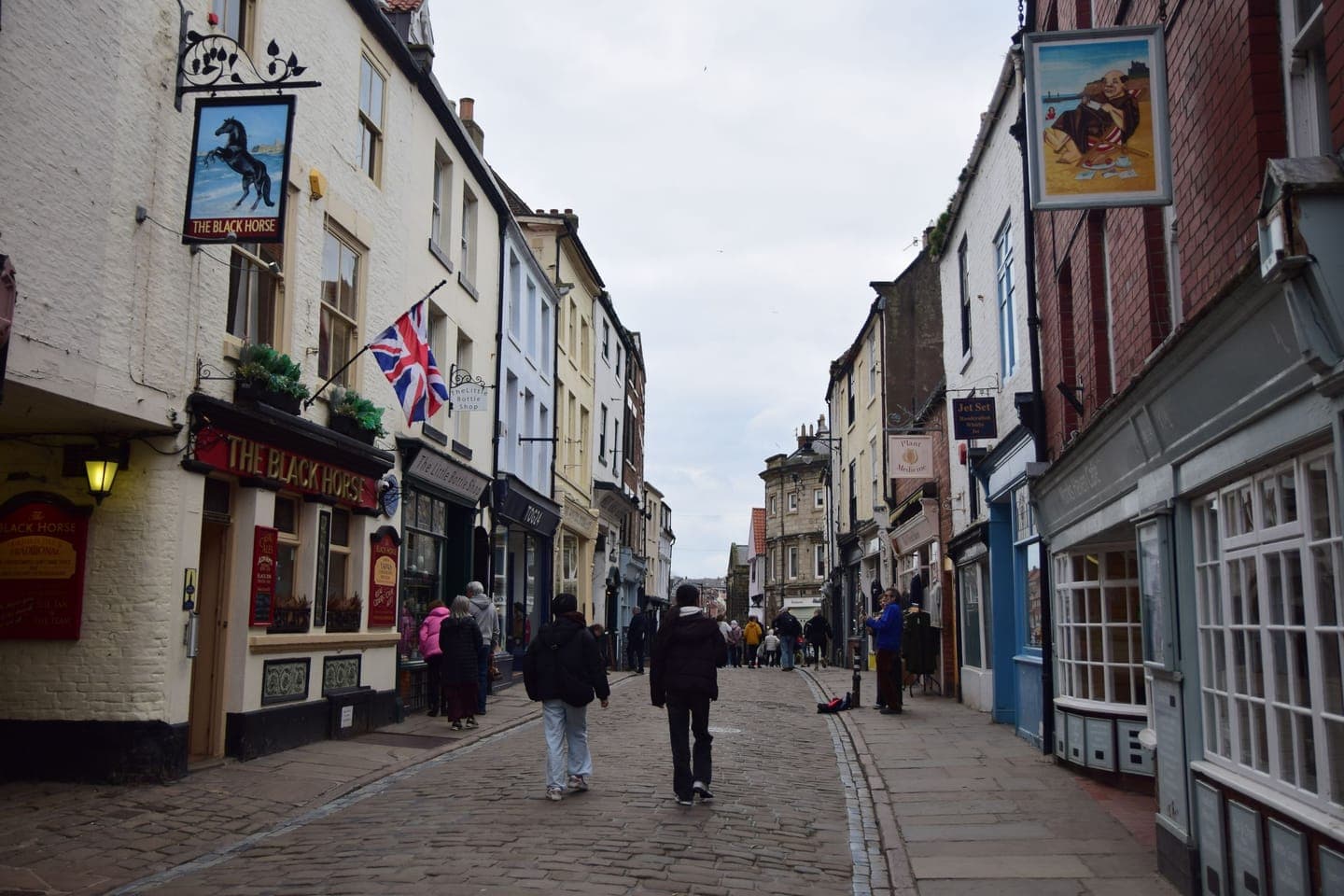 A British high street with shops and Union Jack bunting
